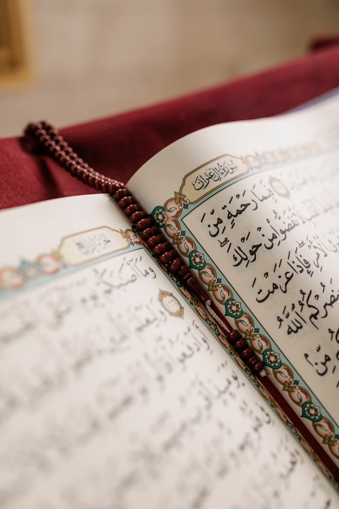 services-04 Detailed image of an open Quran with prayer beads, symbolizing Muslim culture and spirituality.